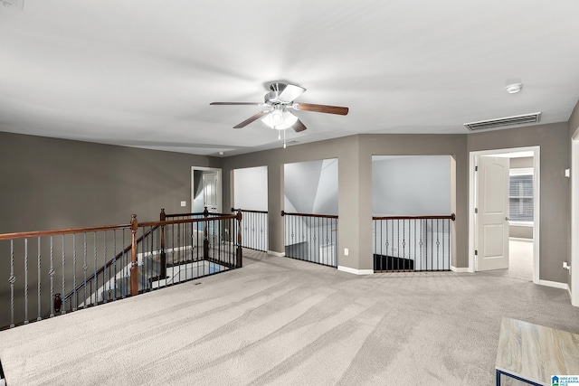 unfurnished room with ceiling fan, carpet flooring, baseboards, and a smoke detector