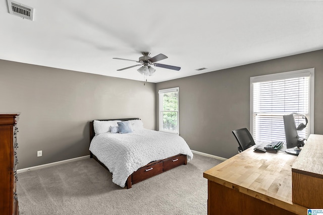 carpeted bedroom featuring baseboards, an office area, and a ceiling fan