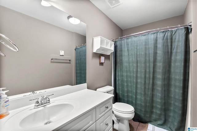 bathroom featuring tile patterned flooring, vanity, and toilet