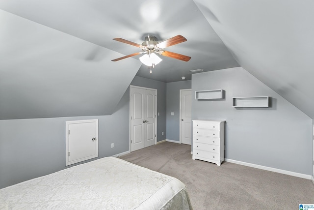 bedroom featuring vaulted ceiling, carpet, baseboards, and ceiling fan