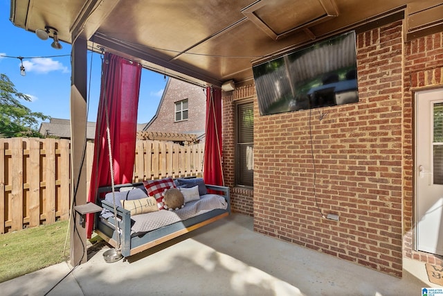 view of patio featuring fence