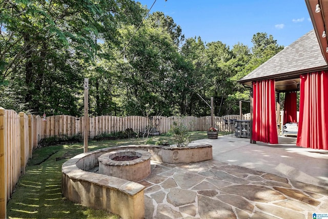 view of patio with an outdoor fire pit and a fenced backyard
