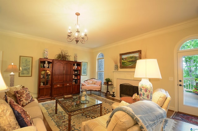 living area featuring a chandelier, ornamental molding, wood finished floors, and a fireplace with flush hearth