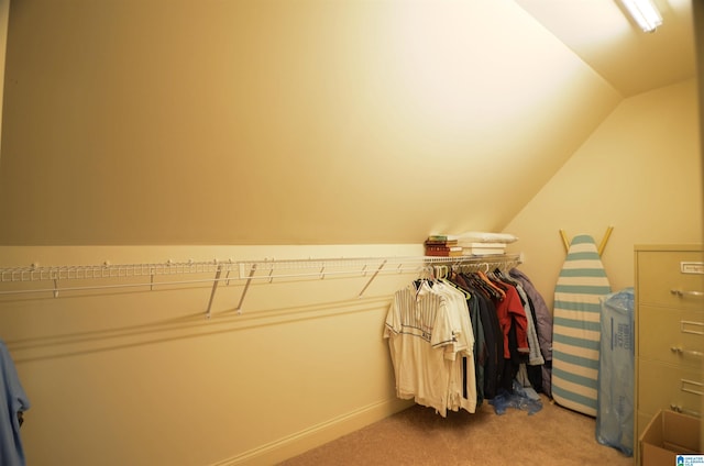 spacious closet featuring vaulted ceiling and carpet flooring