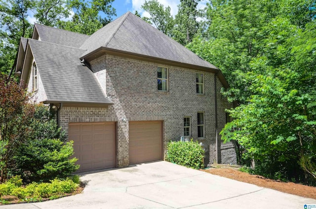4173 Eagle Crest Dr, Birmingham, AL 35242 - view of property exterior featuring brick siding, concrete driveway, a garage, and roof with shingles