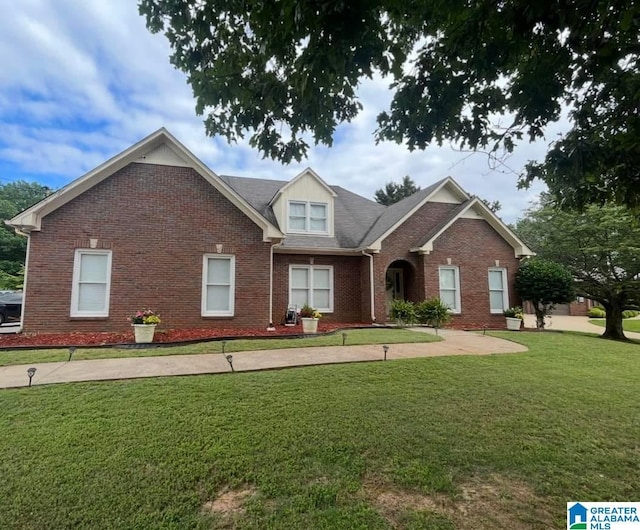 view of front of home with brick siding and a front yard