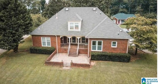view of front of home with a front lawn, a porch, and stairs