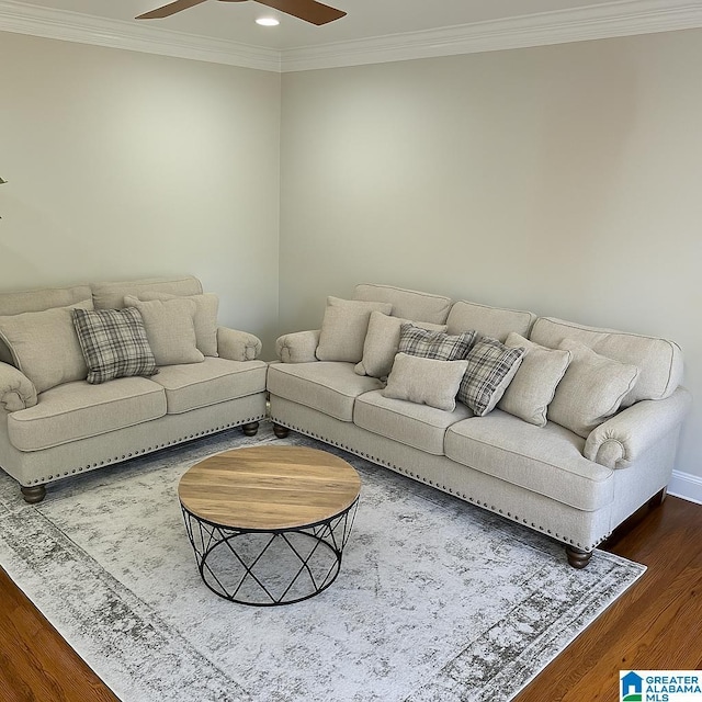 living area with dark wood finished floors, ceiling fan, recessed lighting, ornamental molding, and baseboards