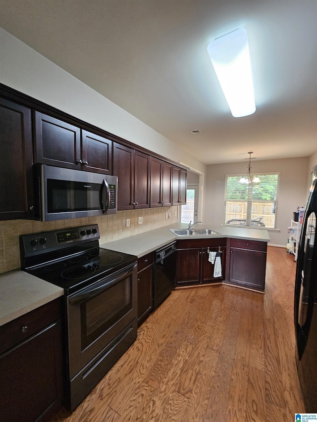 1082 Ivy Pl, Moody, AL 35004 - kitchen with range with electric cooktop, stainless steel microwave, dishwasher, a sink, and light wood-style floors
