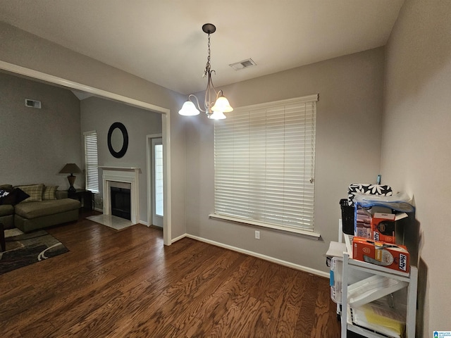 1082 Ivy Pl, Moody, AL 35004 - interior space featuring wood finished floors, a chandelier, baseboards, and a fireplace with flush hearth