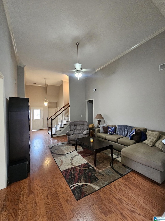 1082 Ivy Pl, Moody, AL 35004 - living area featuring wood finished floors, ornamental molding, stairs, and a ceiling fan