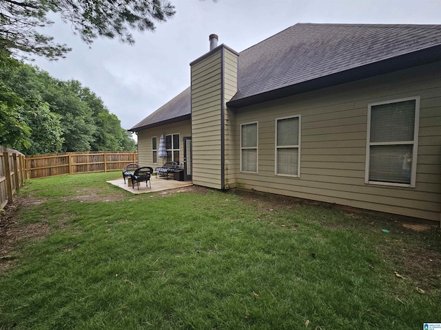 1082 Ivy Pl, Moody, AL 35004 - rear view of house with a patio, roof with shingles, a chimney, and an outdoor fire pit