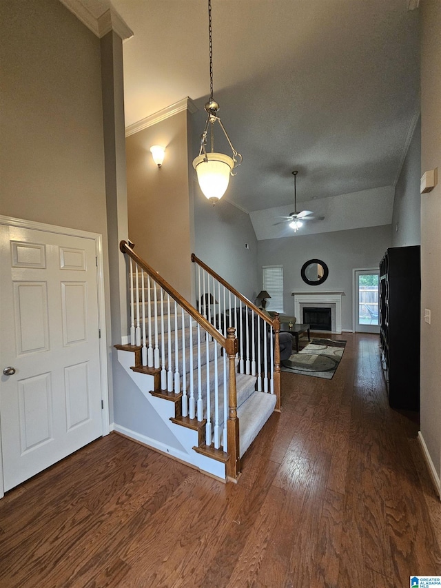 1082 Ivy Pl, Moody, AL 35004 - staircase featuring hardwood / wood-style floors, a ceiling fan, baseboards, ornamental molding, and vaulted ceiling