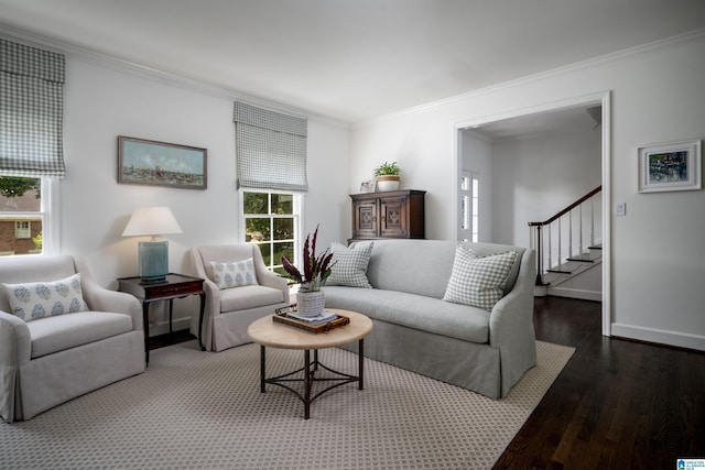 living room featuring wood finished floors, ornamental molding, stairway, and baseboards