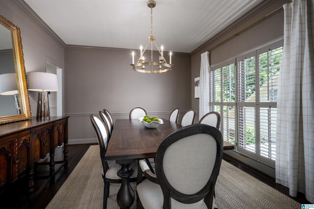 dining area featuring dark wood-style floors, a chandelier, and ornamental molding