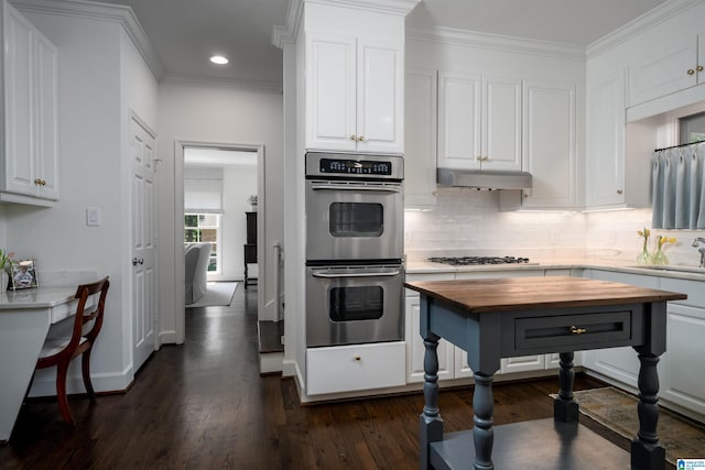 kitchen featuring wooden counters, double oven, dark wood finished floors, white cabinets, and crown molding