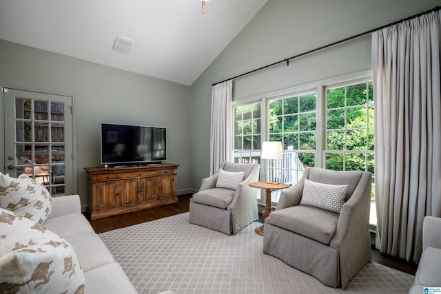 living area featuring wood finished floors and vaulted ceiling