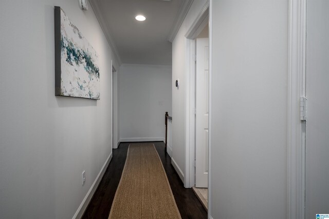 hall featuring crown molding, dark wood finished floors, baseboards, and recessed lighting