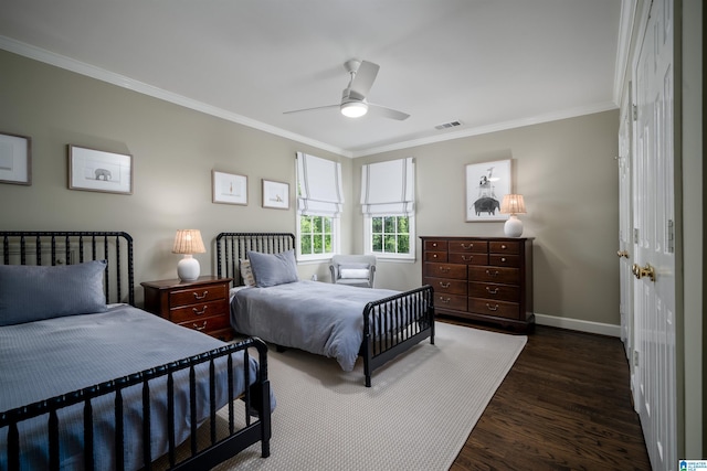 bedroom with ornamental molding, dark wood finished floors, baseboards, and ceiling fan