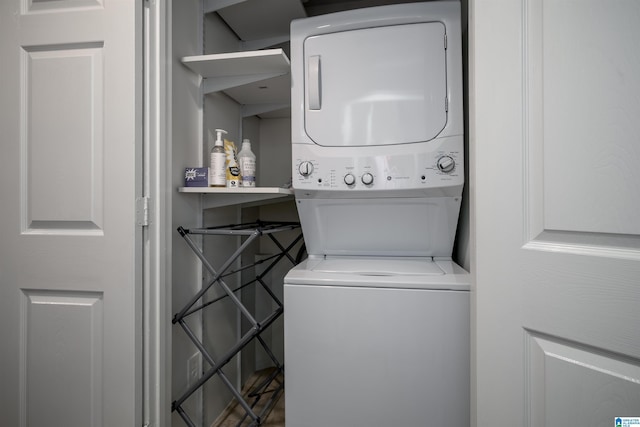laundry room featuring stacked washer / drying machine