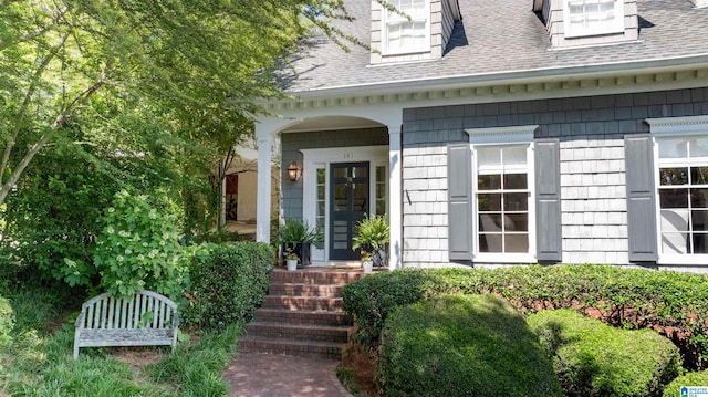 property entrance with a shingled roof