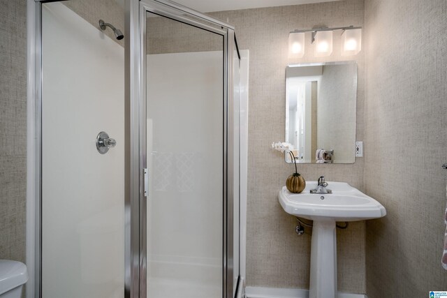 bathroom with a shower stall and toilet