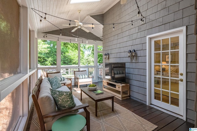 wooden deck featuring an outdoor living space and ceiling fan