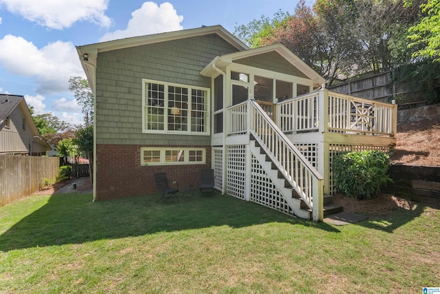 back of property featuring a sunroom, stairs, a deck, and brick siding