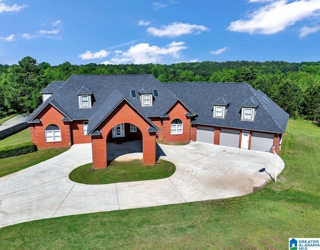 view of front of home with brick siding, driveway, a front lawn, and a garage
