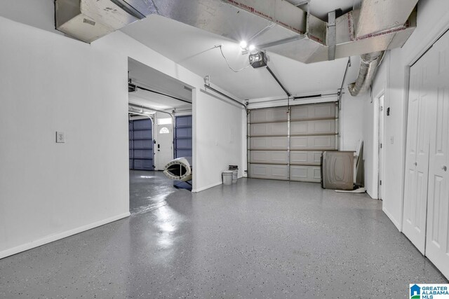 garage featuring a garage door opener and baseboards
