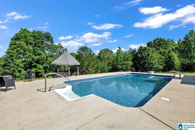 outdoor pool featuring a gazebo and a patio area