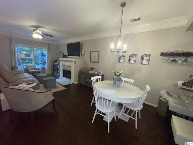 2232 Acton Park Cir, Birmingham, AL 35243 - dining area with a fireplace with flush hearth, ceiling fan, crown molding, a chandelier, and wood finished floors