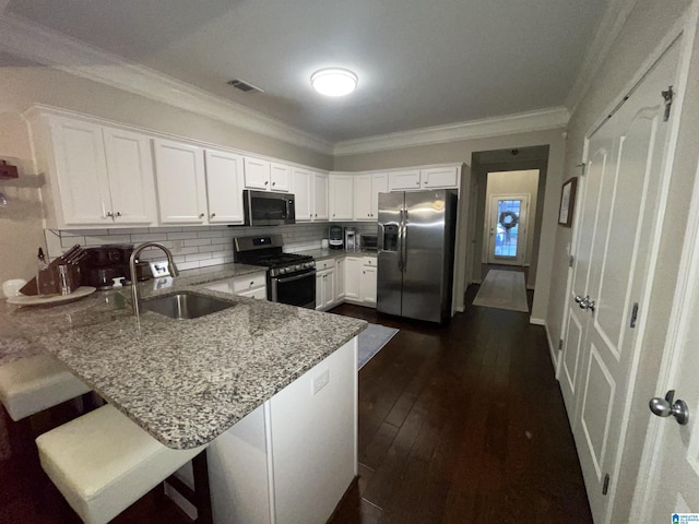 2232 Acton Park Cir, Birmingham, AL 35243 - kitchen featuring stainless steel appliances, a sink, a peninsula, light stone countertops, and crown molding