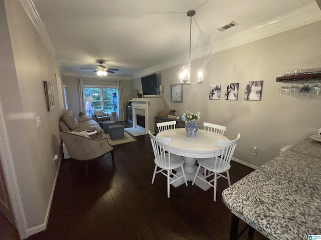 2232 Acton Park Cir, Birmingham, AL 35243 - dining area with crown molding, baseboards, a fireplace, dark wood-type flooring, and a ceiling fan