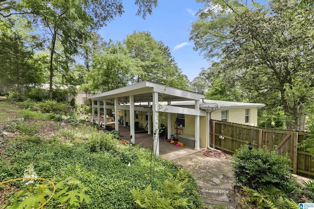back of property featuring fence, a patio, and stucco siding