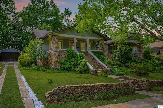 5111 7th Ct S, Birmingham, AL 35212 - craftsman-style home with stairway, stone siding, a front yard, and a porch