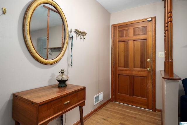 entrance foyer featuring light wood-type flooring and baseboards
