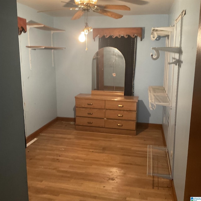 bedroom featuring light wood-type flooring, baseboards, and a ceiling fan