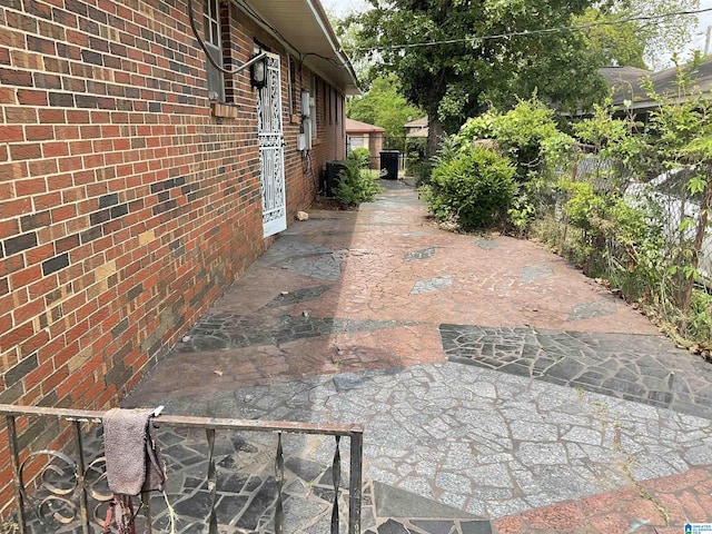 view of side of property with a patio area