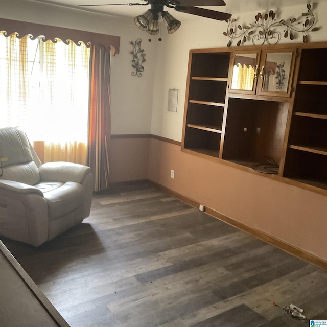 living area featuring ceiling fan, wood finished floors, and baseboards