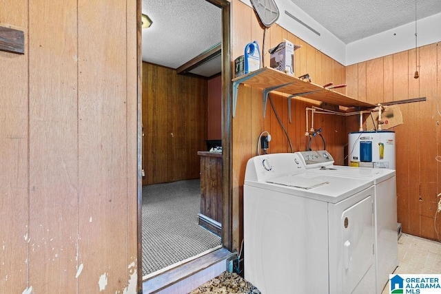5241 County Road 48, Jemison, AL 35085 - laundry area featuring wooden walls, separate washer and dryer, a textured ceiling, and water heater