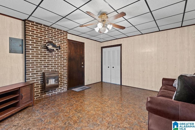 5241 County Road 48, Jemison, AL 35085 - living room with a ceiling fan, wooden walls, electric panel, heating unit, and a drop ceiling