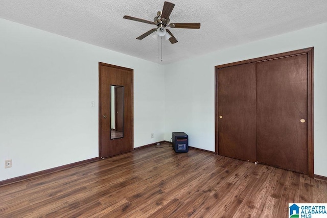 5241 County Road 48, Jemison, AL 35085 - unfurnished bedroom featuring wood finished floors, a textured ceiling, baseboards, a closet, and a ceiling fan