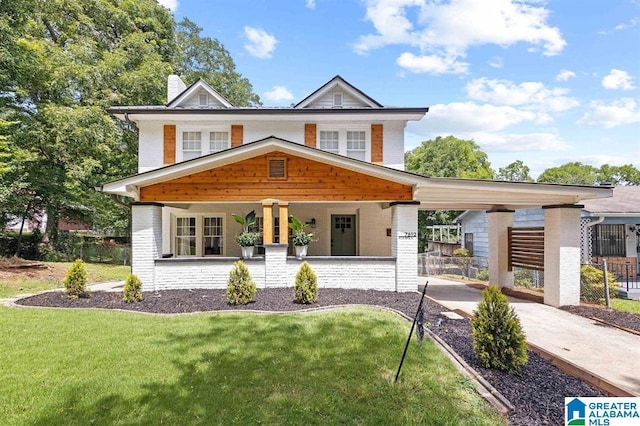 view of front of house with a porch, a chimney, a carport, and brick siding