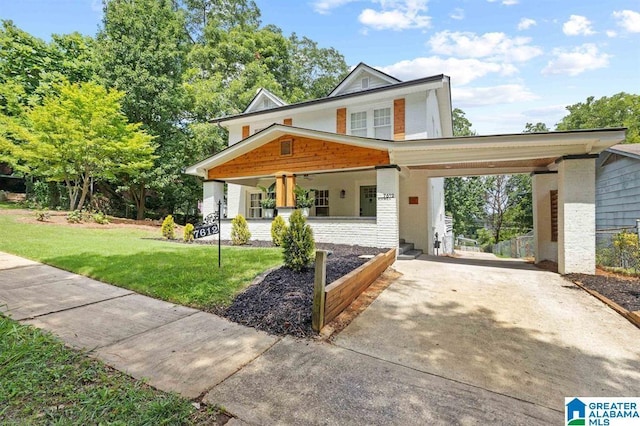 view of front of home with a porch, a front lawn, concrete driveway, a carport, and brick siding