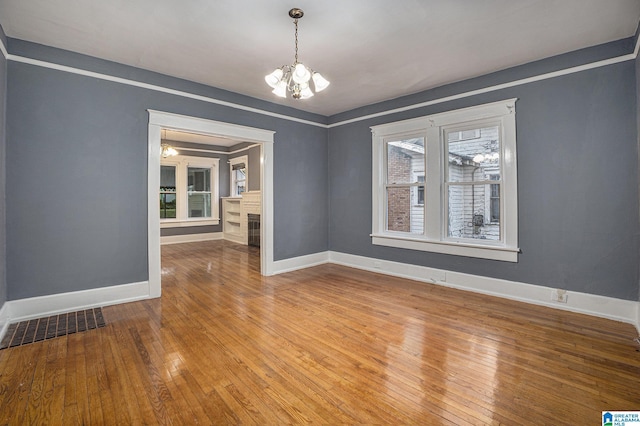 728 41st St, Fairfield, AL 35064 - spare room with a chandelier, hardwood / wood-style flooring, and baseboards