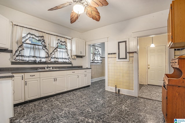 728 41st St, Fairfield, AL 35064 - kitchen featuring a sink, dark countertops, a ceiling fan, and white cabinets