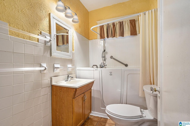 728 41st St, Fairfield, AL 35064 - bathroom featuring toilet, vanity, and tile walls