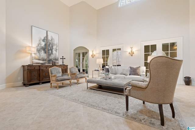 4035 Saint Charles Dr, Hoover, AL 35242 - tiled living area with french doors, a high ceiling, arched walkways, and baseboards