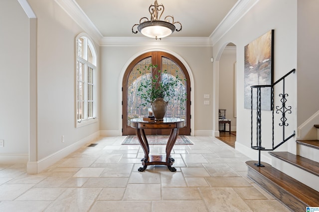4035 Saint Charles Dr, Hoover, AL 35242 - entrance foyer with arched walkways, stone tile flooring, ornamental molding, stairway, and baseboards